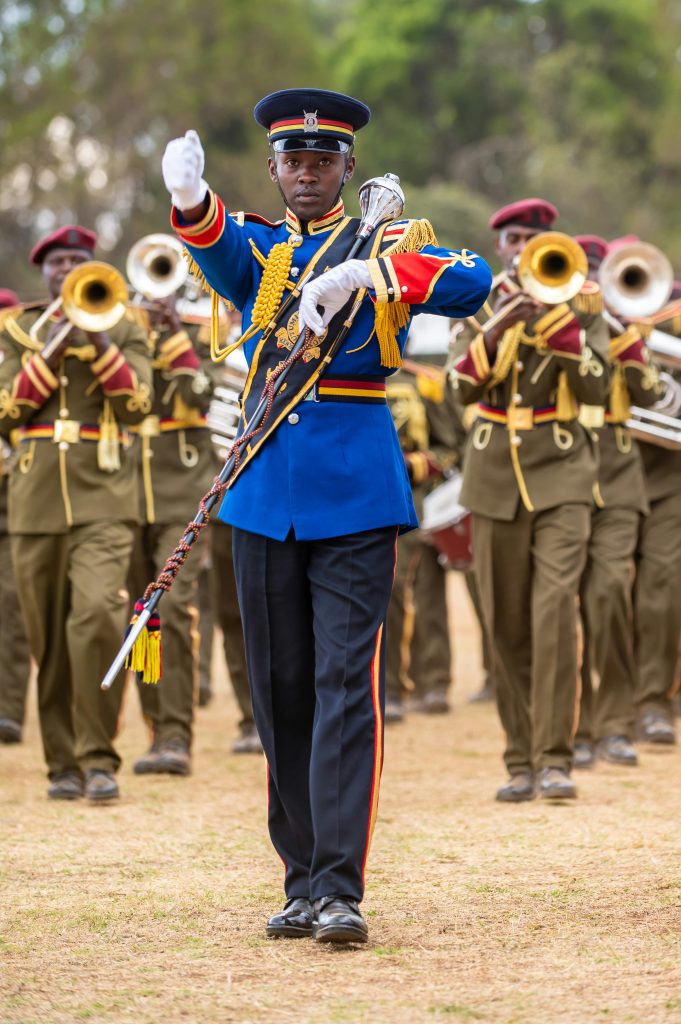 A vibrant military parade in Eldoret, Kenya, featuring uniformed soldiers playing instruments.